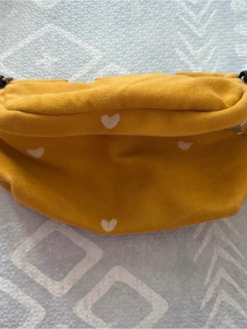 Tula Mustard Yellow Mini Heart-Print hip pouch.